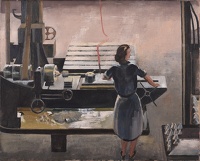 Woman operating a lathe turning the...